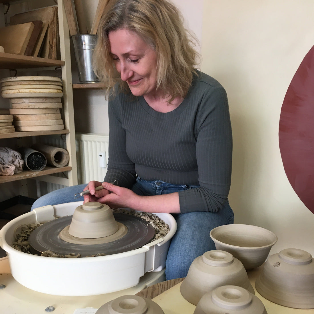 Signe Schmidt working with ceramic wheels and clay in a pottery studio